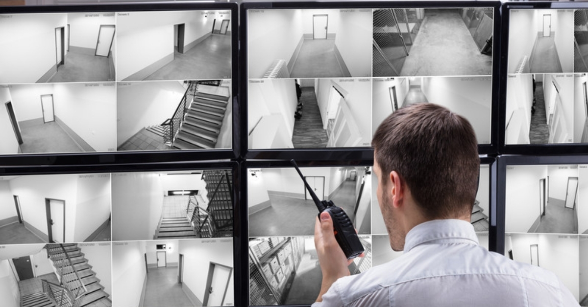 Security guard monitoring CCTV footage - physical security - 24By7Security